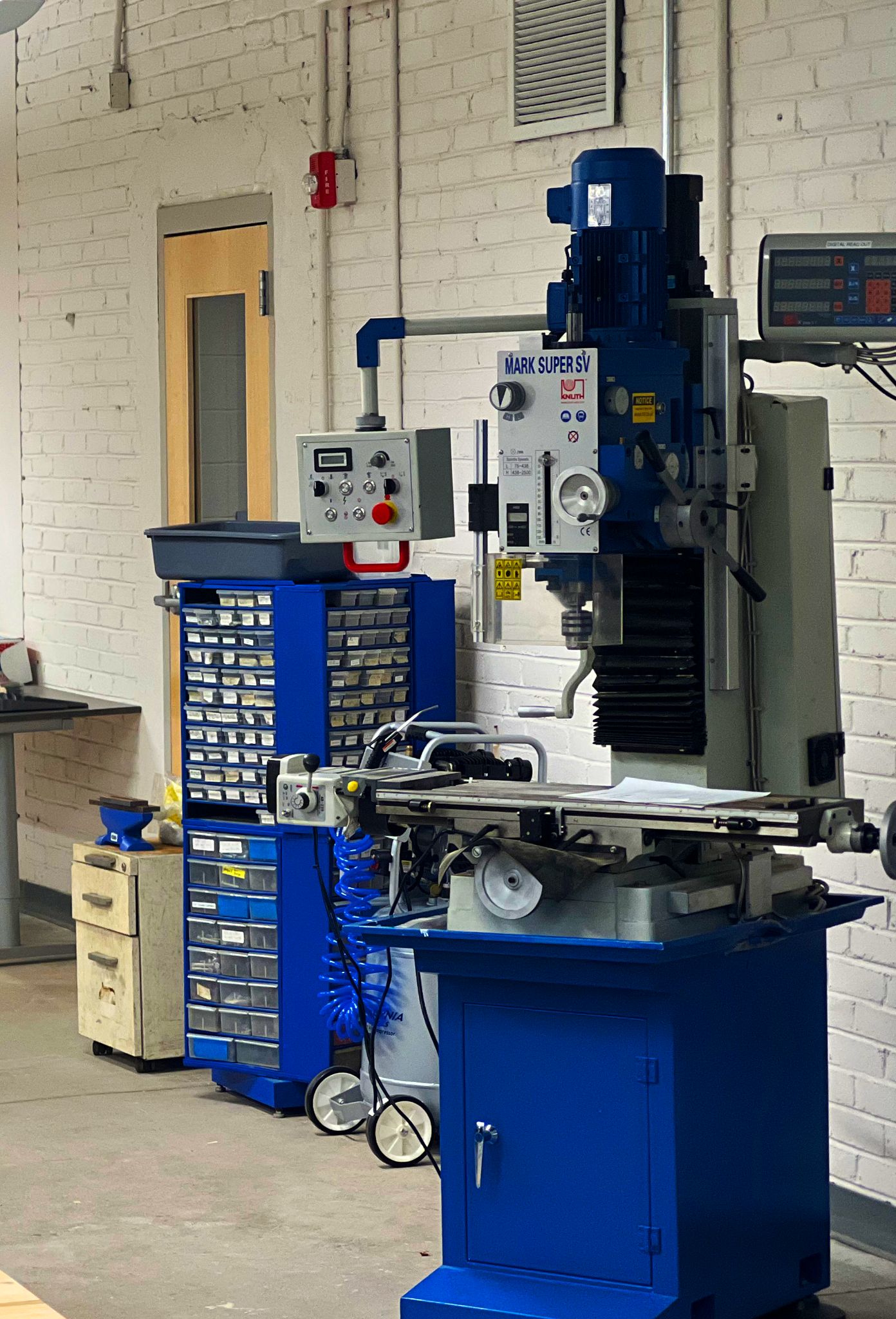 Mill-drill machine in the fully equipped workshop